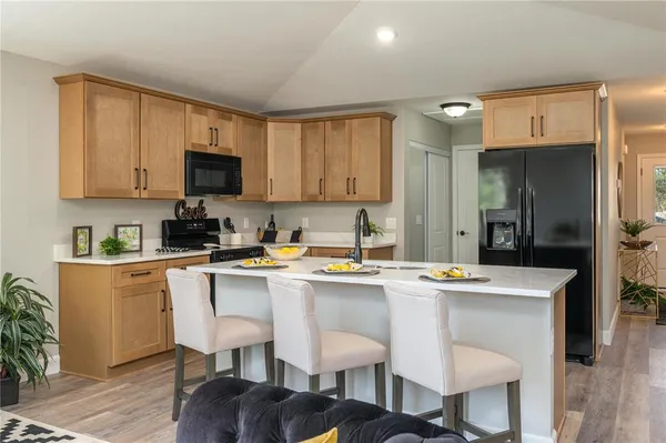a kitchen with stainless steel appliances granite countertop a sink stove and cabinets