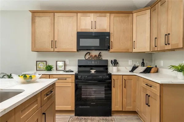 a kitchen with granite countertop a sink and cabinets