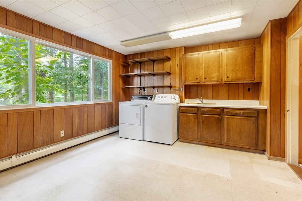 738 Lowell Road Groton, MA 01450 - Photo 18 of 30 a kitchen with a stove a refrigerator and storage