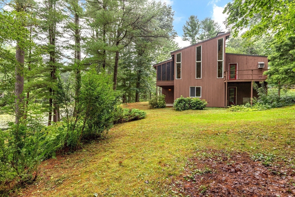 738 Lowell Road Groton, MA 01450 - Photo 22 of 30 a view of a house with backyard and trees