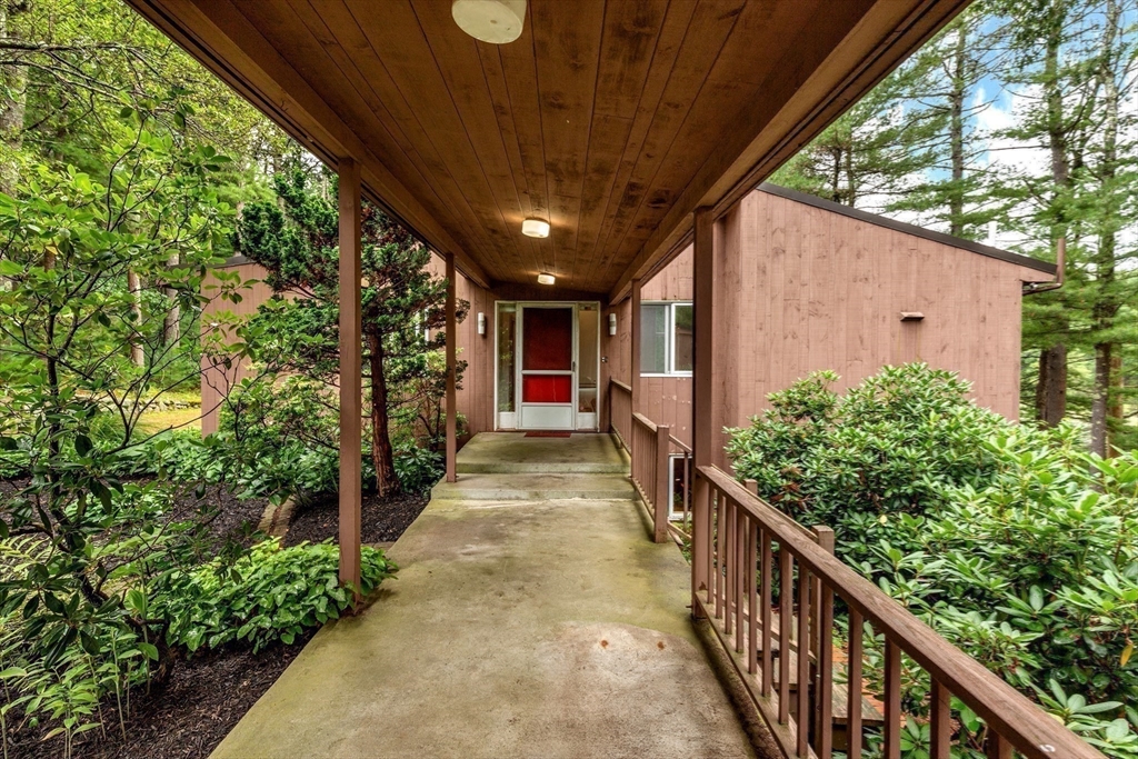 738 Lowell Road Groton, MA 01450 - Photo 25 of 30 a view of a pathway of a house with wooden stairs