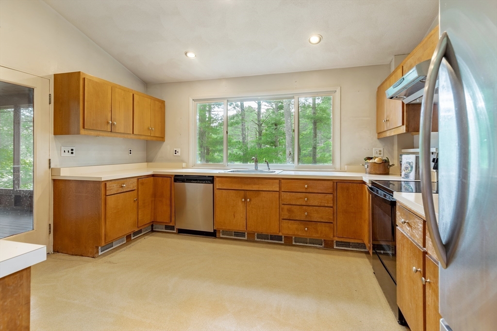 738 Lowell Road Groton, MA 01450 - Photo 10 of 30 a kitchen with stainless steel appliances granite countertop a stove a sink and a refrigerator