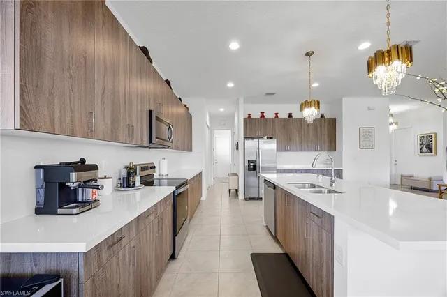 a kitchen with stainless steel appliances a sink stove and cabinets