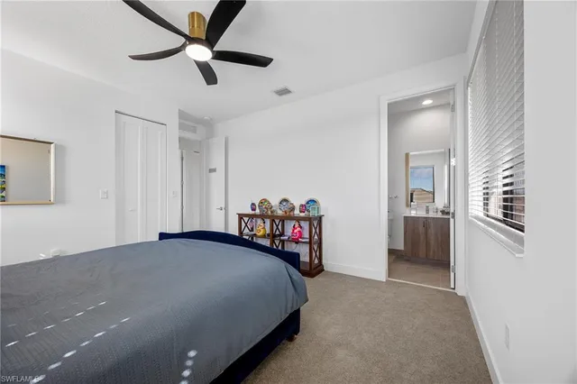 a bedroom with a bed dresser and window