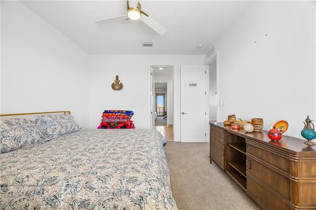 a bedroom with a bed and a dresser in it