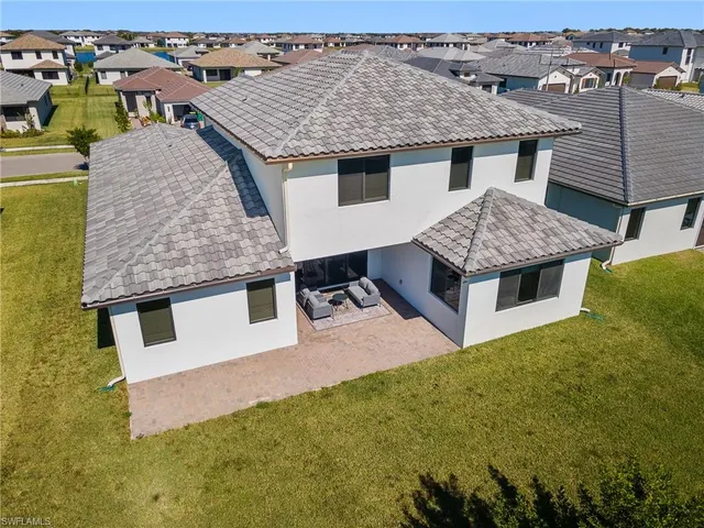 an aerial view of a house with a swimming pool