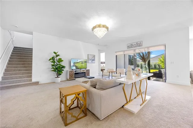 a living room with fireplace furniture and a potted plant