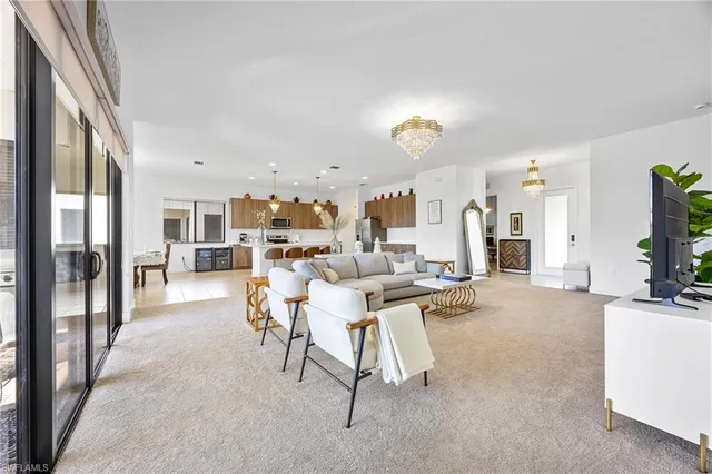 a view of a livingroom with furniture and a flat screen tv
