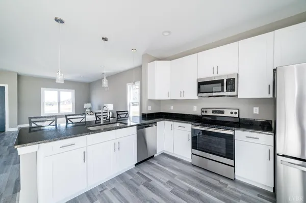 a kitchen with sink a microwave and cabinets