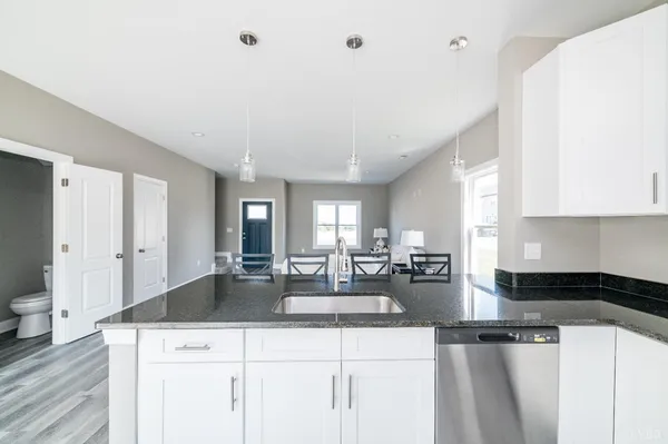 a kitchen with sink refrigerator and cabinets