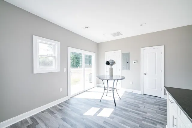 a view of a livingroom with wooden floor and a window