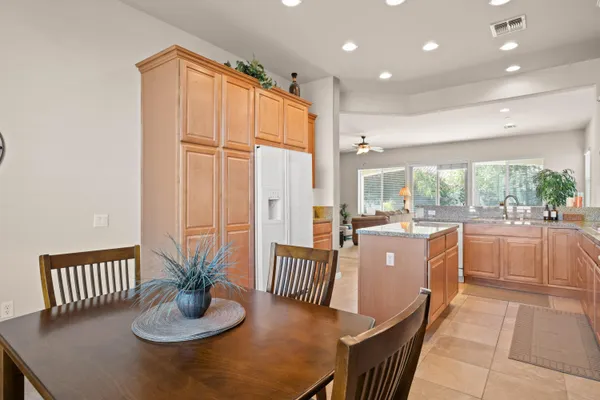 a kitchen with a table chairs and wooden floor