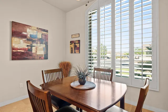a dining room with furniture and wooden floor