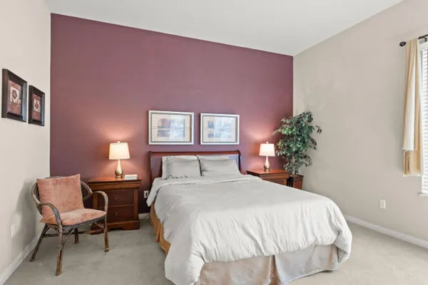 a bedroom with a bed and a potted plant