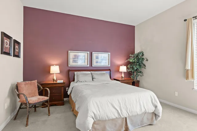 a bedroom with a bed and a potted plant