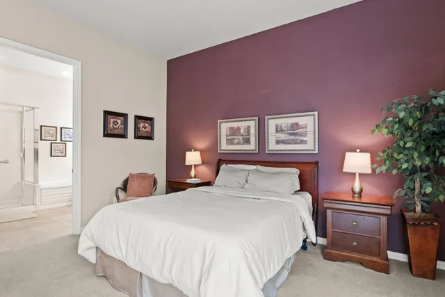 a bedroom with a bed and a potted plant