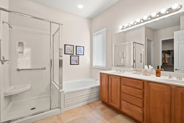 a bathroom with a tub a sink shower and mirror