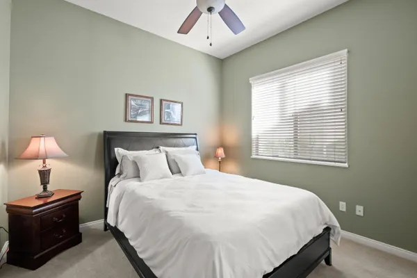 a large bed sitting in a bedroom next to a lamp