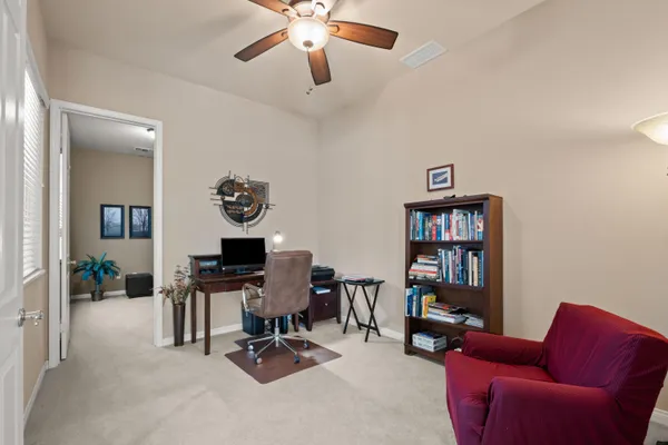 a view of a livingroom with workspace and a couch
