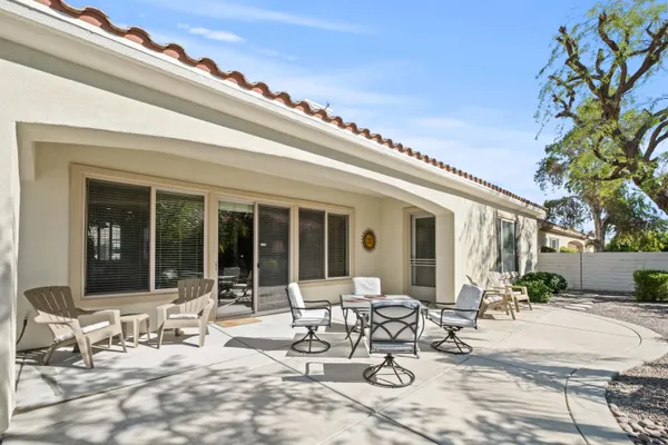 a view of a patio with table and chairs and potted plants