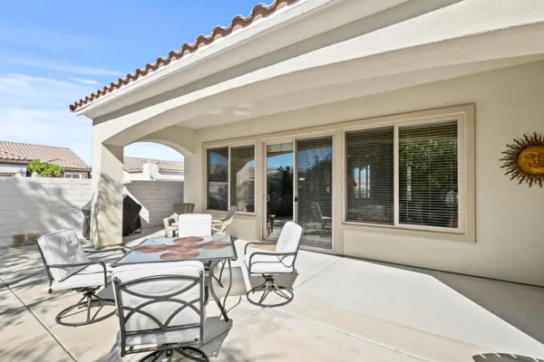 a dining room with furniture and large windows