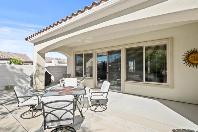 a dining room with furniture and large windows