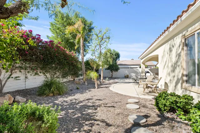 a view of a backyard with plants and a patio