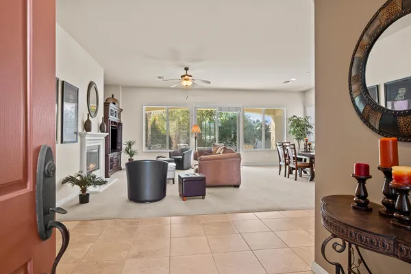 a living room with furniture a window and a flat screen tv