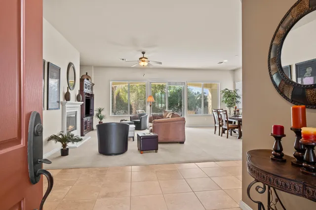 a living room with furniture a window and a flat screen tv