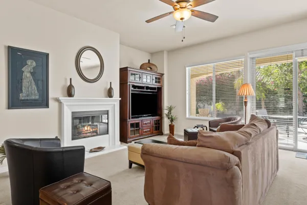 a living room with furniture a fireplace and a flat screen tv