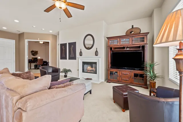 a living room with furniture a flat screen tv and a fireplace