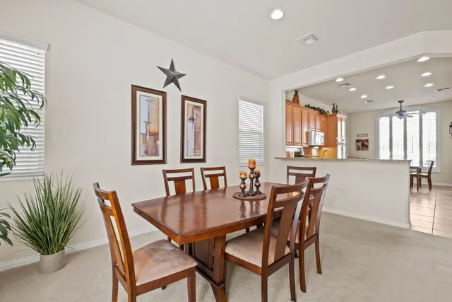 a view of a dining room with furniture and a potted plant