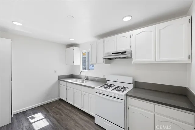 a kitchen with stainless steel appliances granite countertop a sink and a stove