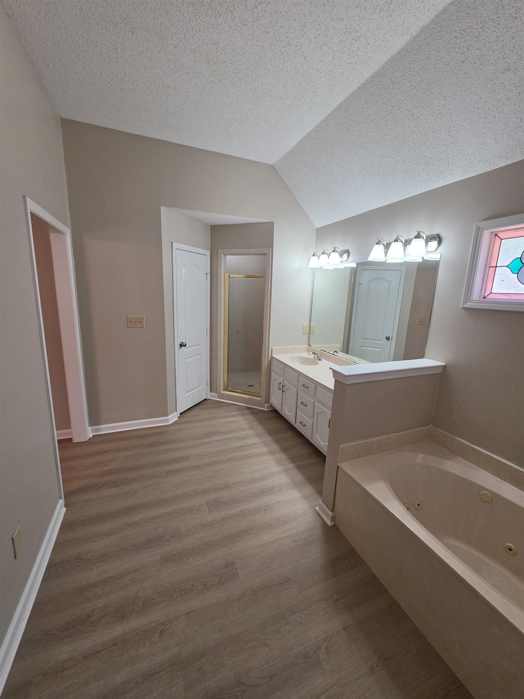5570 Patsy Circle West Memphis, TN 38125 - Photo 15 of 22 Bathroom with vanity, light wood finished floors, a shower stall, and a tub with jets