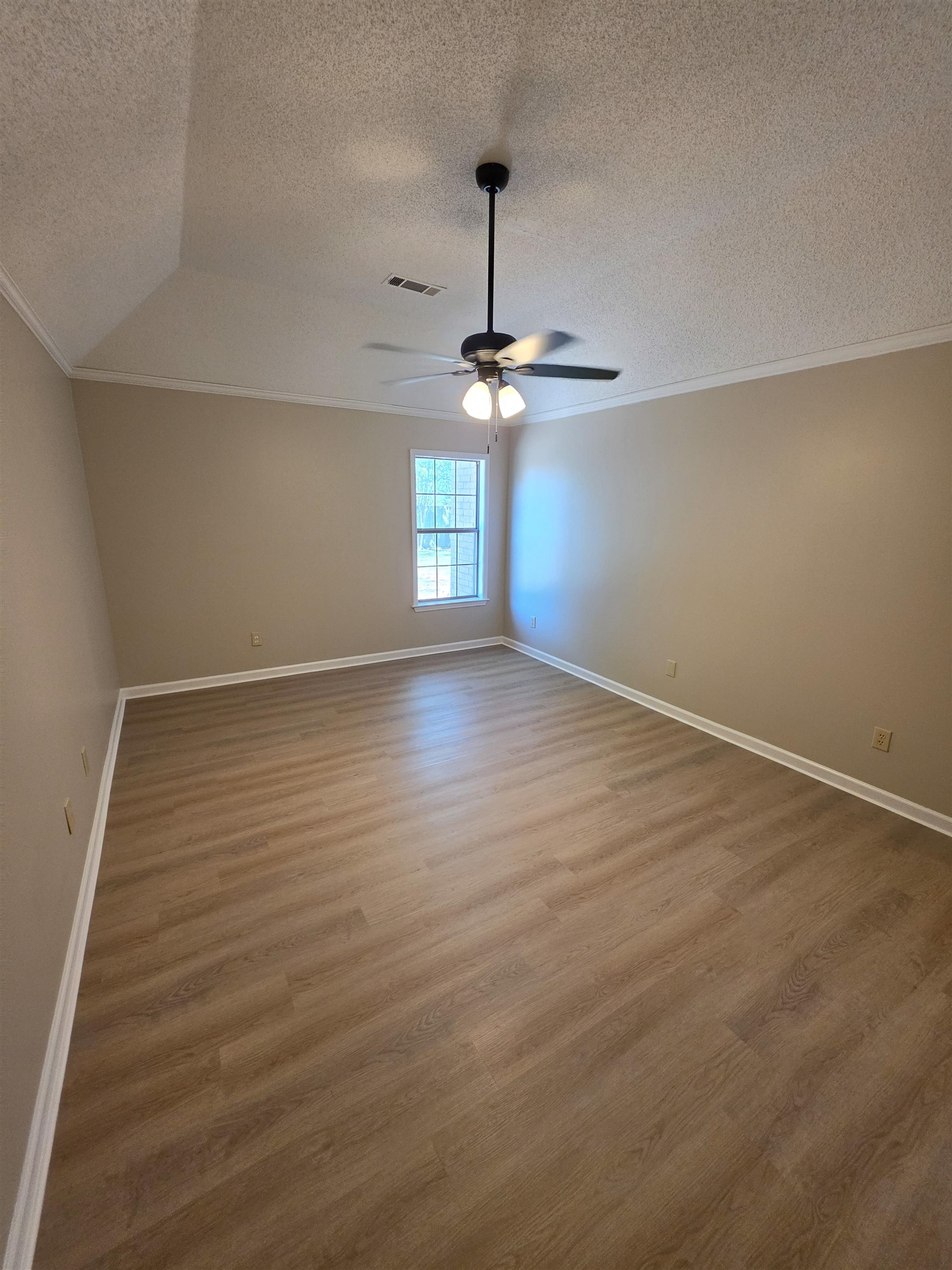 5570 Patsy Circle West Memphis, TN 38125 - Photo 17 of 22 Primary Bedroom with crown molding, wood finished floors, a textured ceiling, and ceiling fan