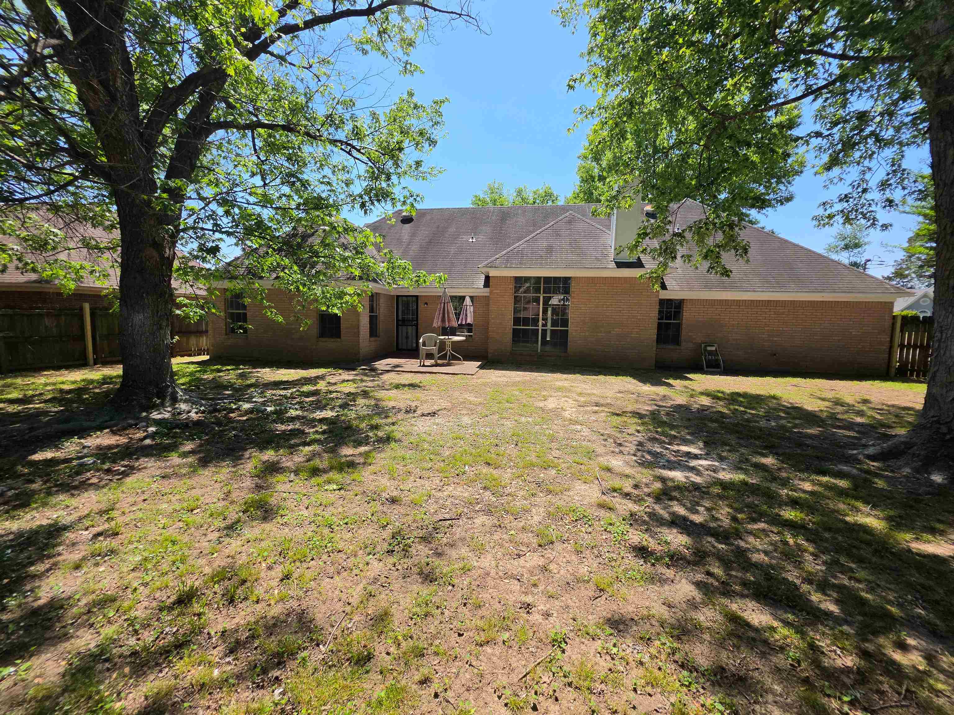 5570 Patsy Circle West Memphis, TN 38125 - Photo 2 of 22 Back of property with a patio area, brick siding, and a fenced backyard