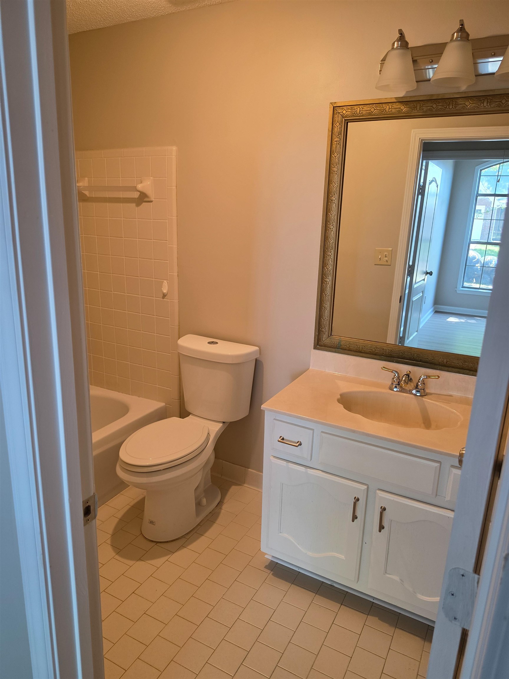 5570 Patsy Circle West Memphis, TN 38125 - Photo 21 of 22 Full bath featuring vanity, light tile patterned flooring, and tub / shower combination