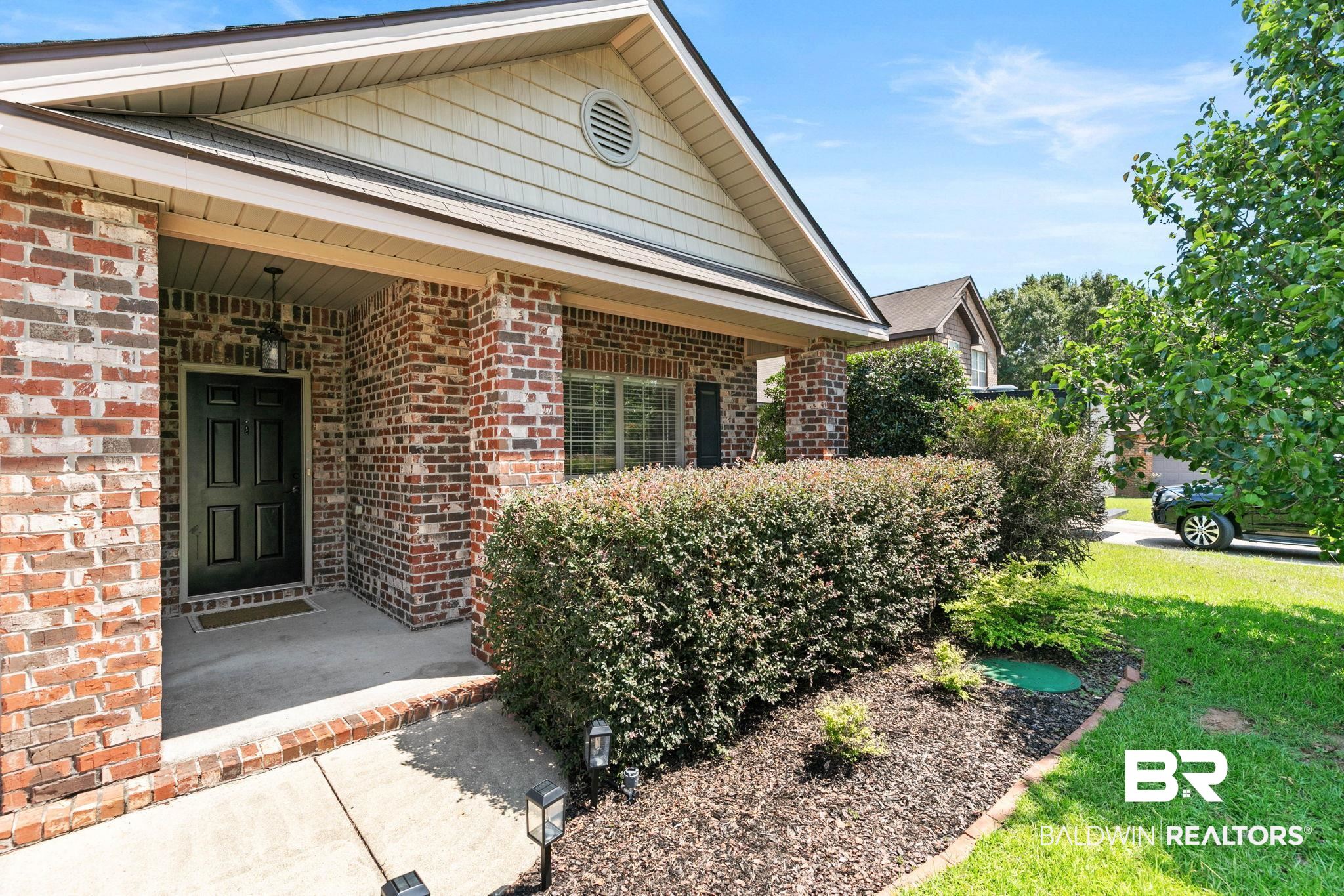 2216 Livingstone Court Mobile, AL 36695 - Photo 4 of 62 Brick exterior with a covered entry and a paneled front door