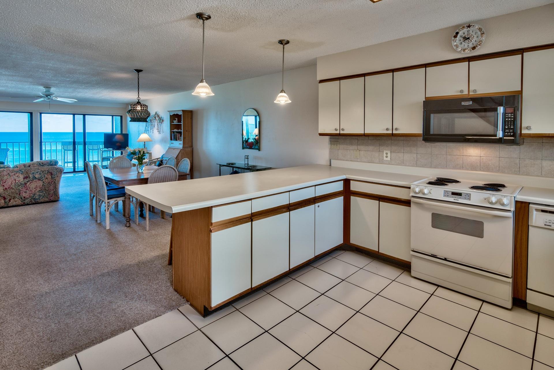 214 Blue Mountain Road, Unit 122 Santa Rosa Beach, FL 32459 - Photo 15 of 32 a kitchen with stainless steel appliances granite countertop a stove a sink and a microwave