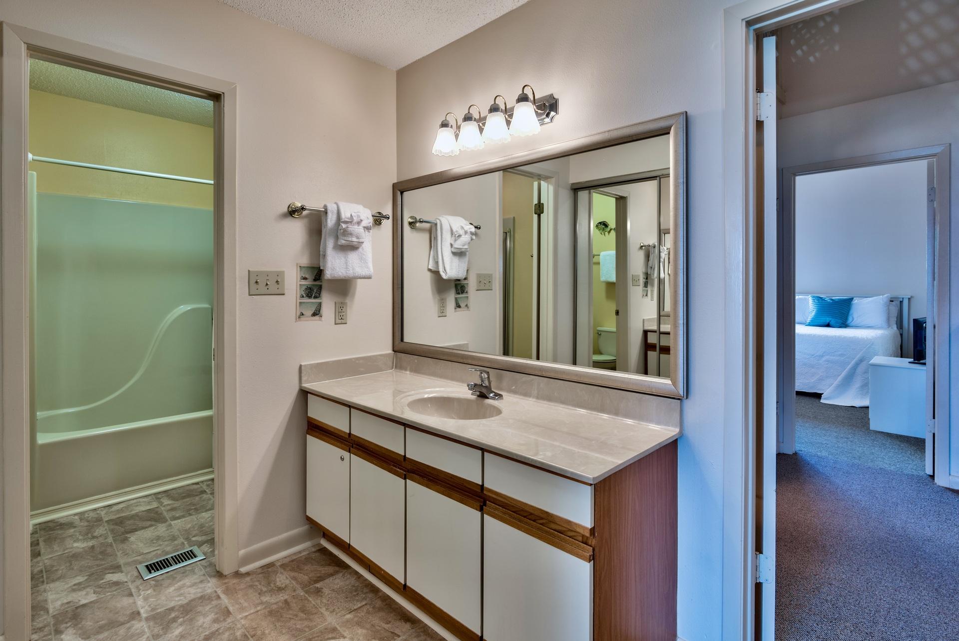 214 Blue Mountain Road, Unit 122 Santa Rosa Beach, FL 32459 - Photo 24 of 32 a en suite bathroom with a granite countertop sink and a mirror