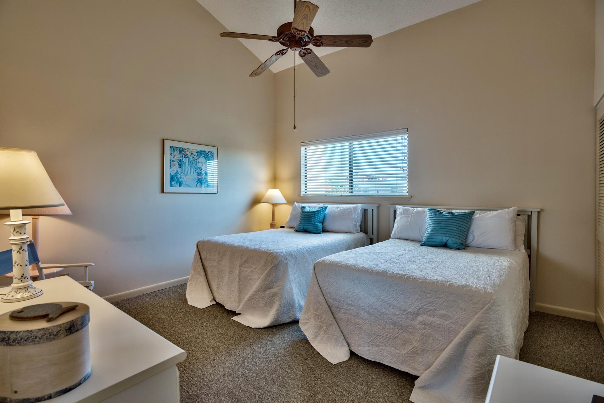 214 Blue Mountain Road, Unit 122 Santa Rosa Beach, FL 32459 - Photo 27 of 32 a bedroom with two beds and a chandelier