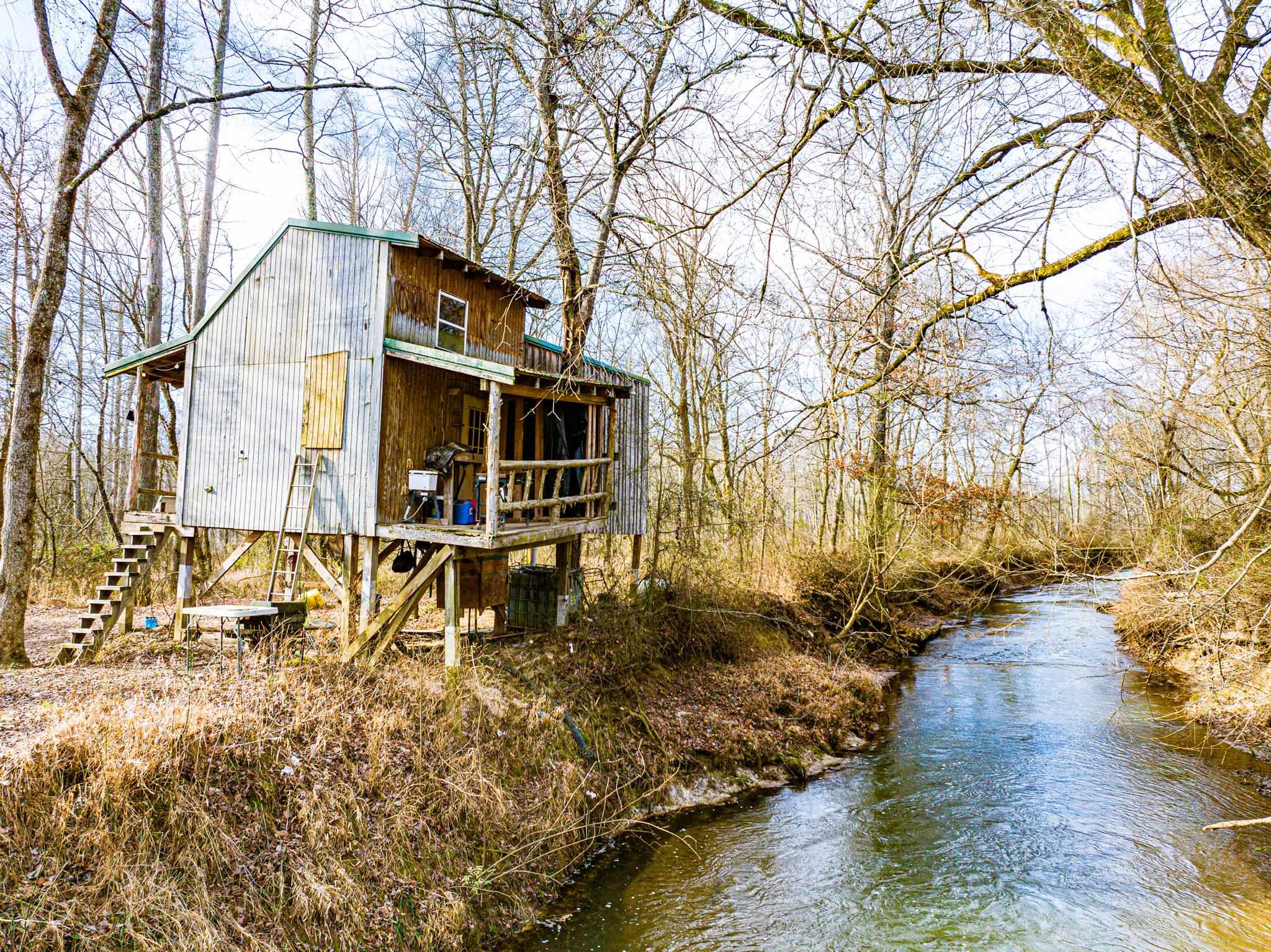 0 Puryear Road Cottage Grove, TN 38224 - Photo 7 of 40 View of side of property featuring a water view and stairs