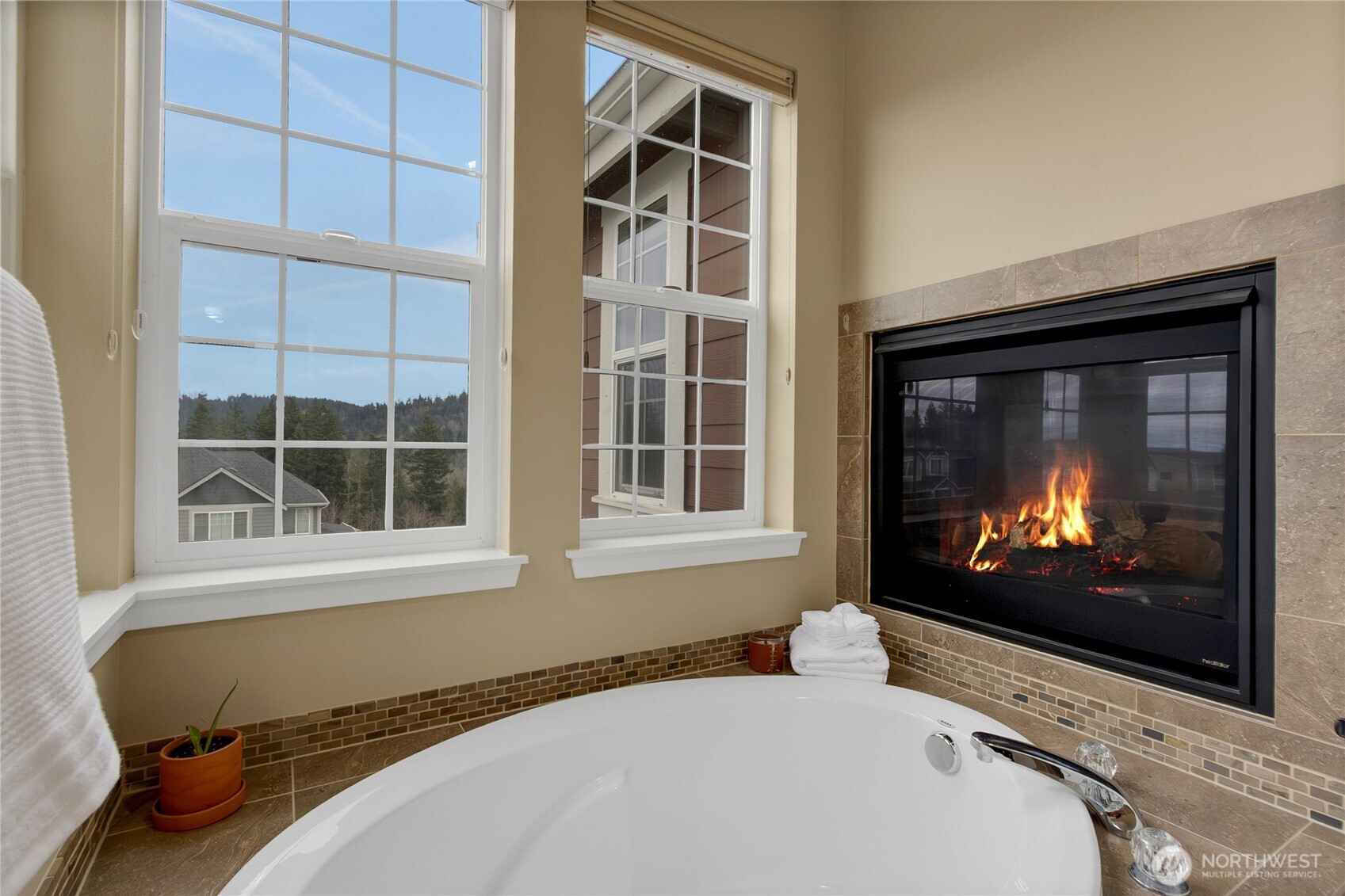889 Lund Street Buckley, WA 98321 - Photo 12 of 25 a living room with a fireplace and a flat screen tv