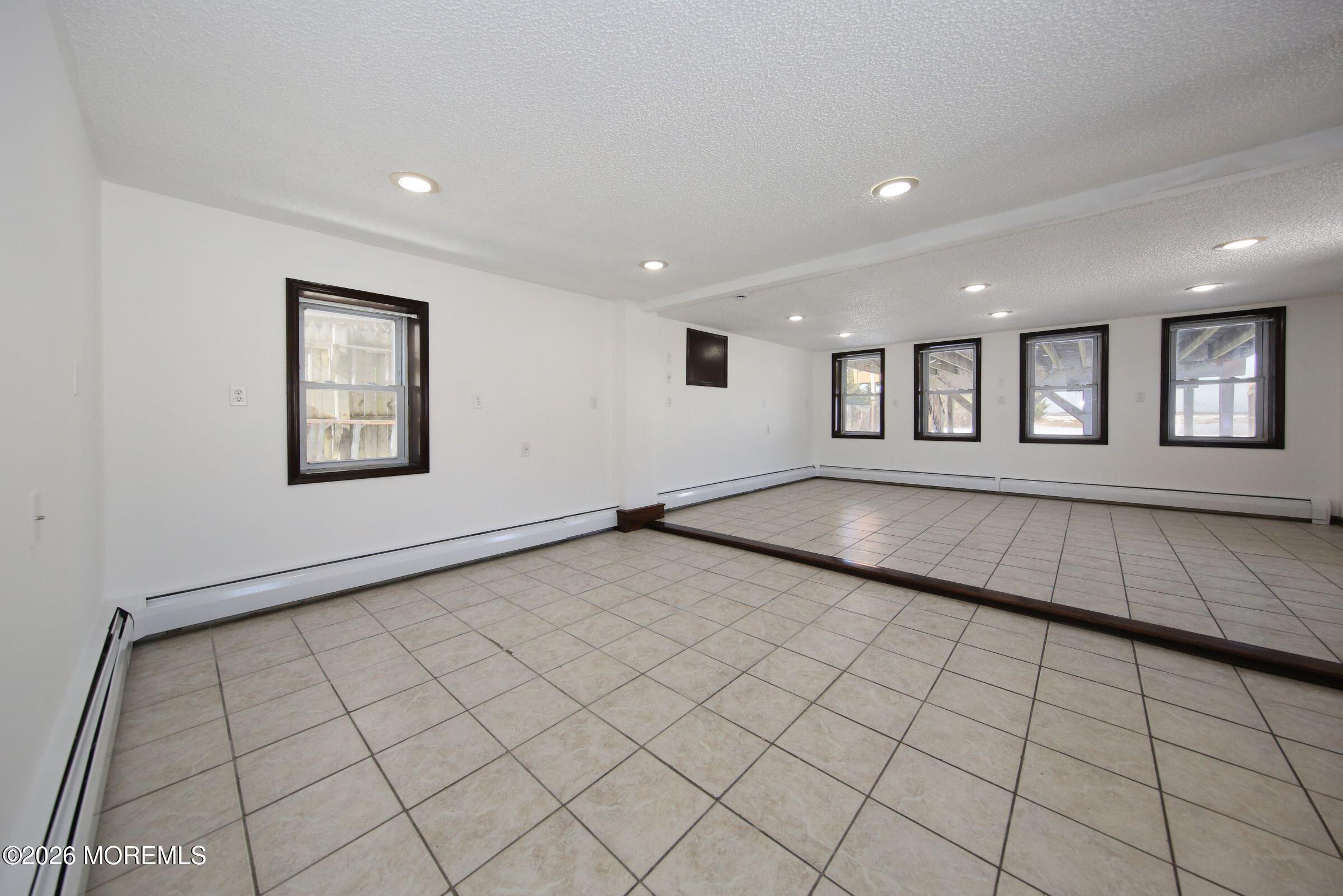 60 Matthew Street, Unit 1 Highlands, NJ 07732 - Photo 6 of 33 an empty room with windows