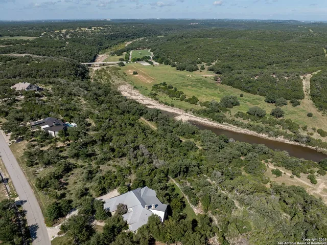 an aerial view of a house with a yard