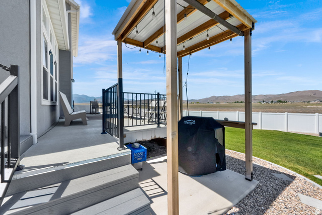 1857 Thunder Gulch Road Eagle Mountain, UT 84005 - Photo 42 of 50 Expansive concrete patio area with a covered outdoor cooking space