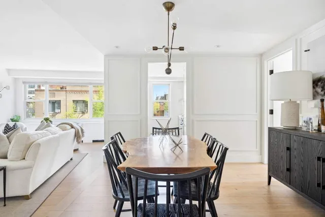 a living room with furniture potted plant and a window
