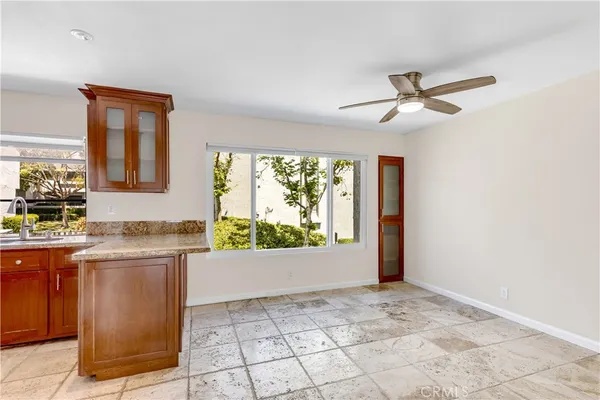 a bathroom with a granite countertop toilet and a sink