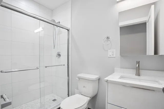 a bathroom with a sink toilet and shower
