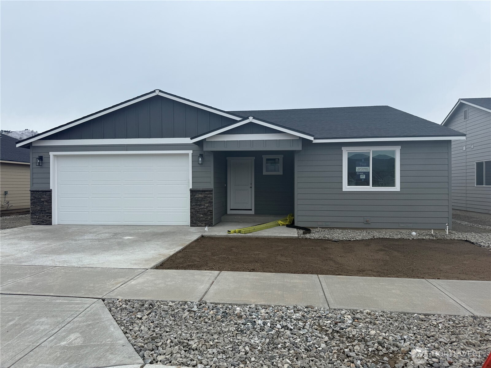 104 Salmon Drive Wenatchee, WA 98801 - Photo 1 of 35 a front view of a house with a yard and garage
